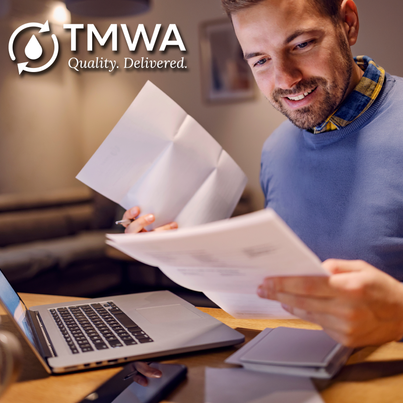 Image of man paying bills. 